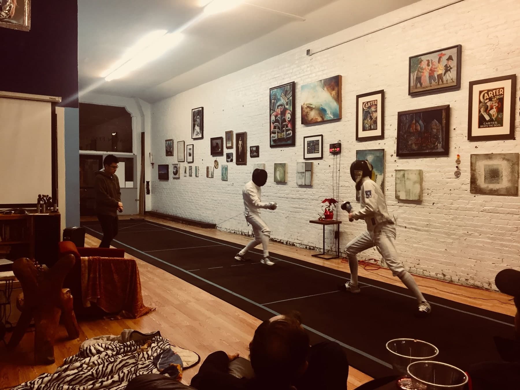 The salle at Marin Fencing Academy, its walls hung with prints